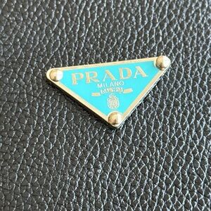 Repurposed blue Prada triangle logo flat back